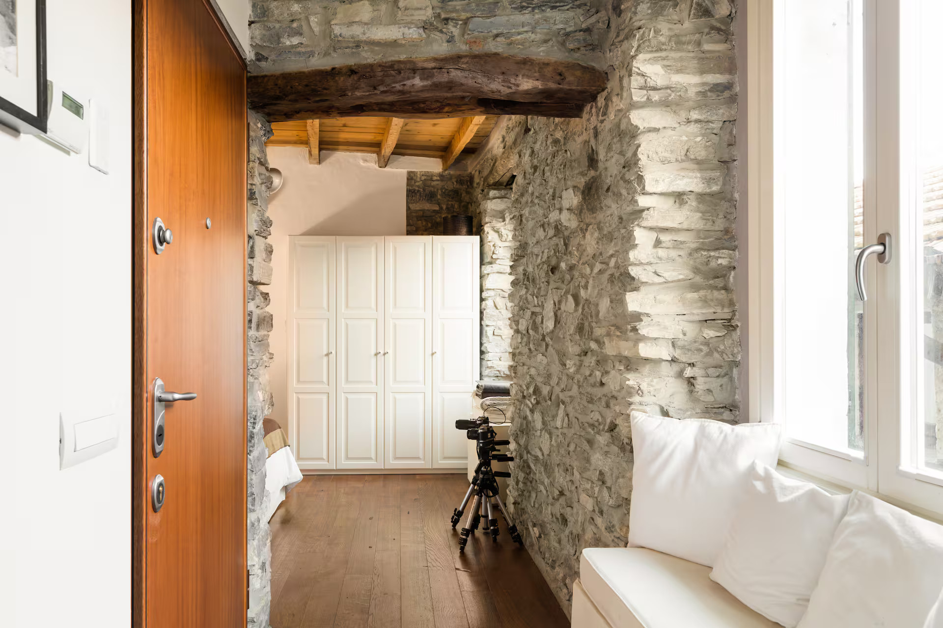 entrance grey stone walls old beams apartment Lake Como rustic chic decor entrance grey stone walls old beams apartment Lake Como rustic chic decor