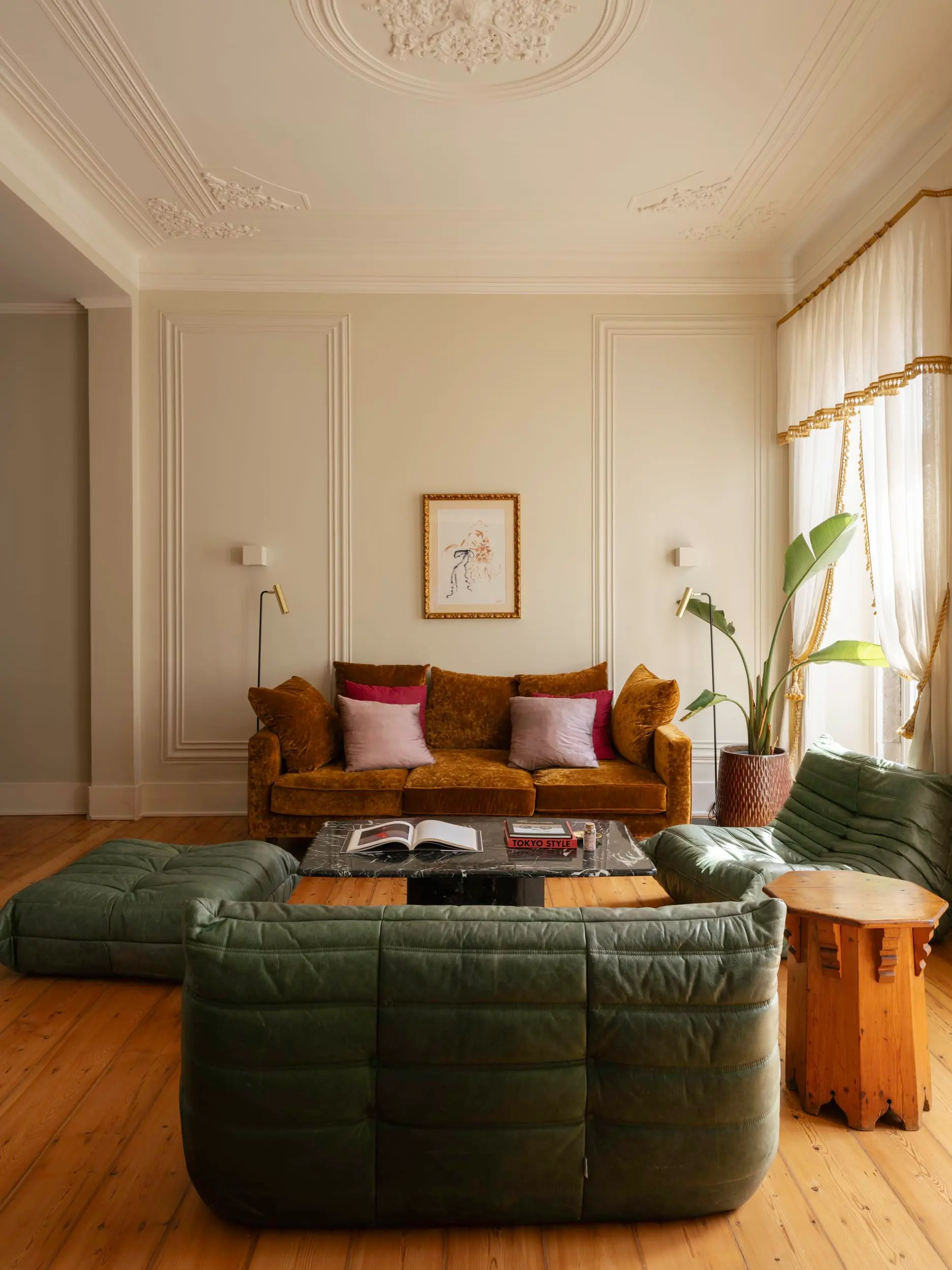 living room with green leather Togo sofa vintage apartment in Lisbon with refreshing garden living room with green leather Togo sofa vintage apartment in Lisbon with refreshing garden