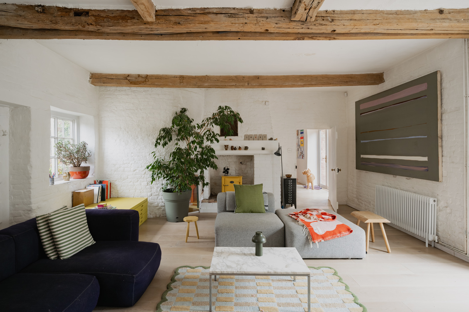 Living room with yellow stove vintage decor renovated 18th-century house in the English countryside Living room with yellow stove vintage decor renovated 18th-century house in the English countryside