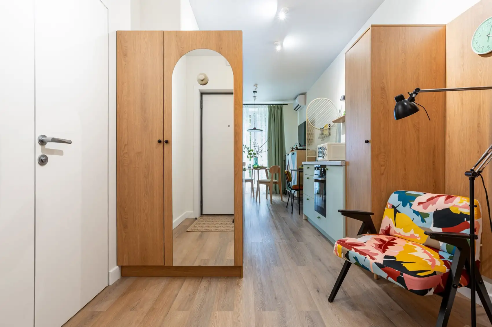 entryway with cupboards and armchair