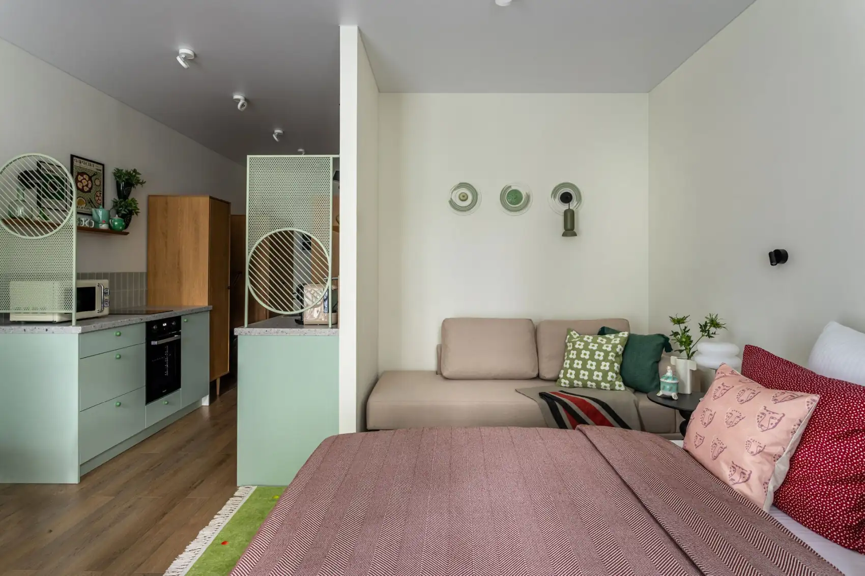 green kitchen living area and bed 30m2 studio in 70's style