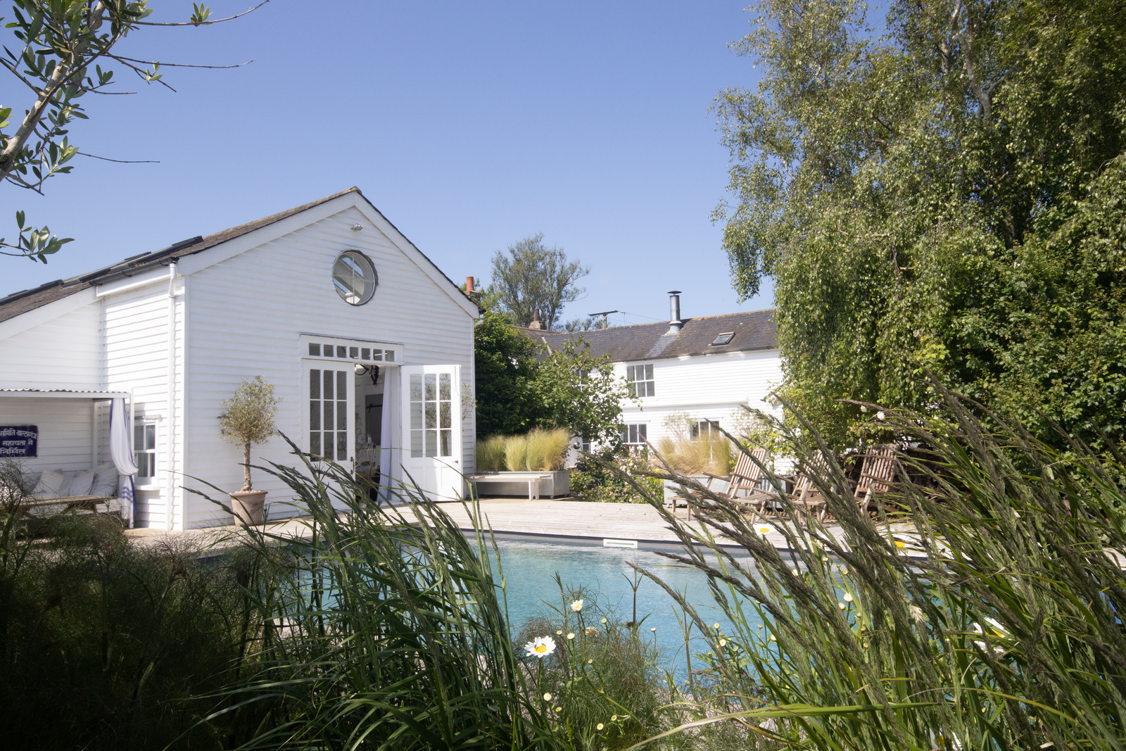 white house in English countryside with pool white house in English countryside with pool
