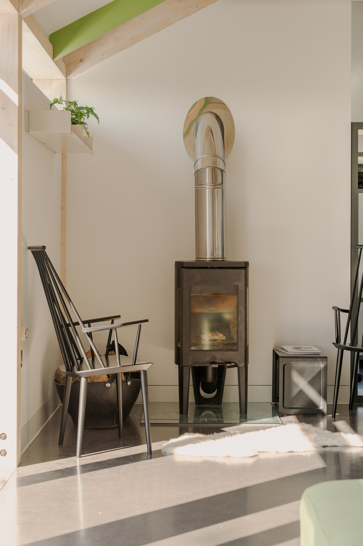 stove in living room concrete floor bay windows contemporary house in Wales "The chicken shed"