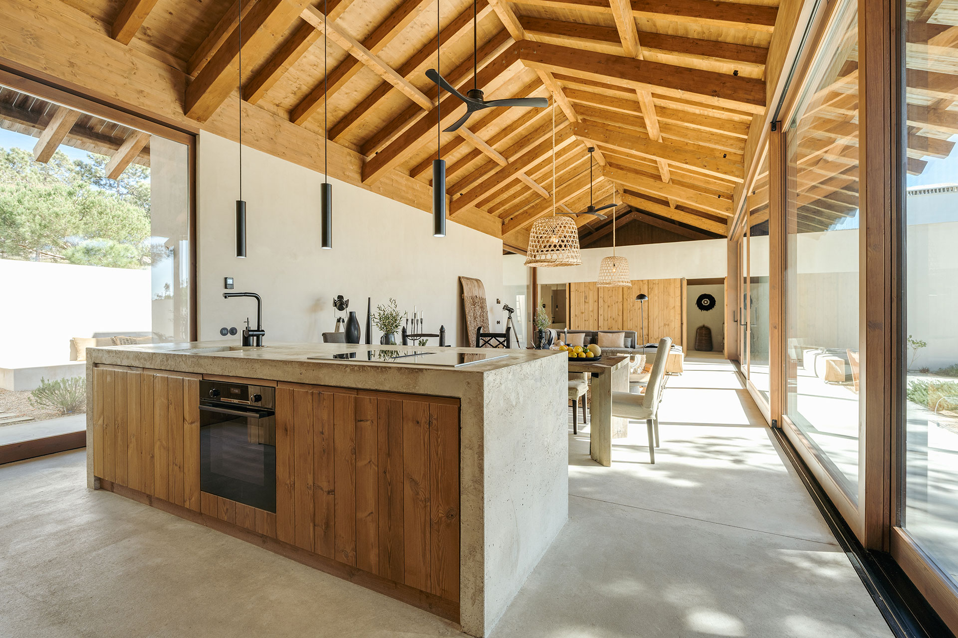 cuisine avec îlot béton et salle à manger et salon double hauteur plafond bois décoration naturelle Villa Sandstone Comporta cuisine avec îlot béton et salle à manger et salon double hauteur plafond bois décoration naturelle Villa Sandstone Comporta