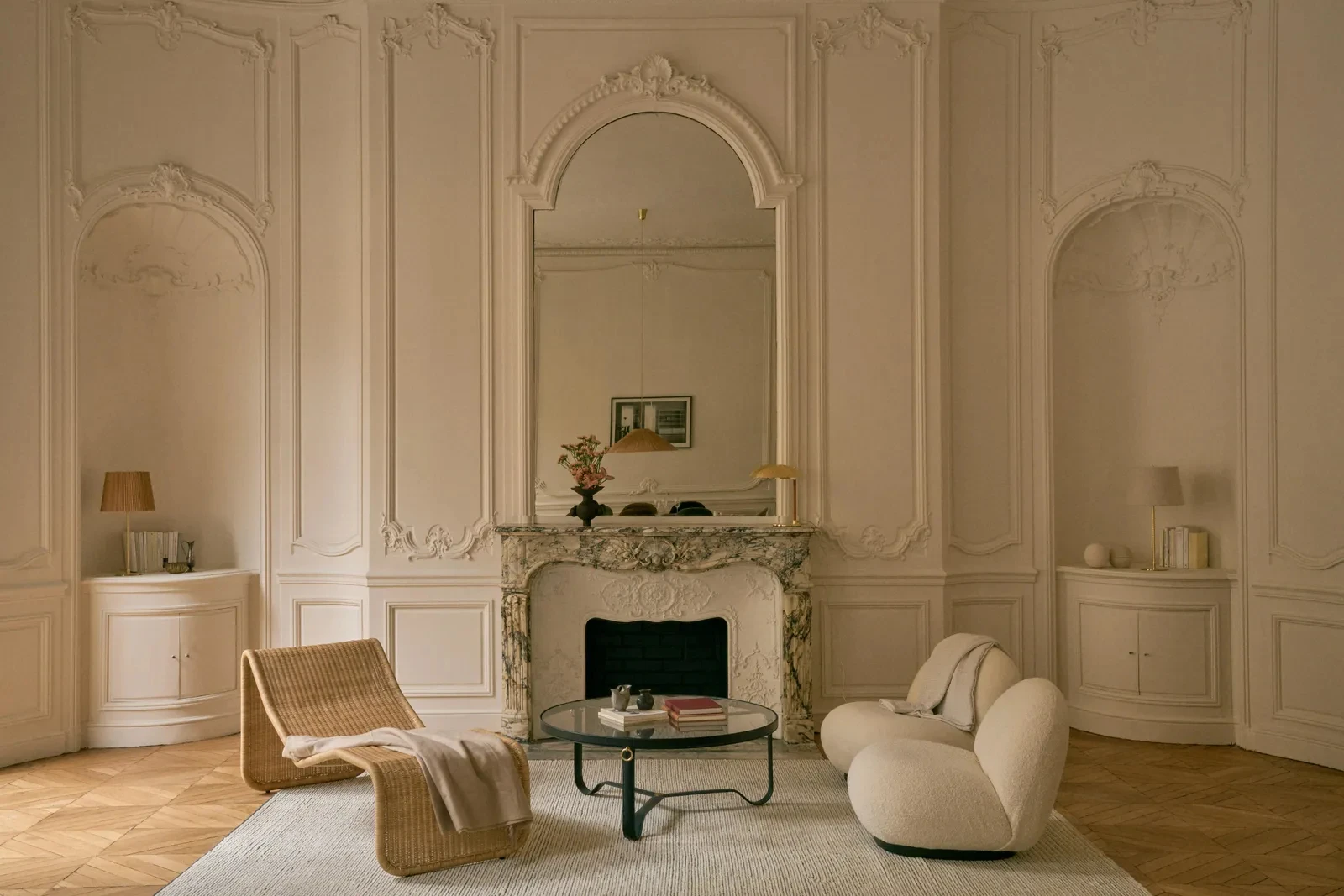 living room with period mouldings and fireplace Haussmann-style apartment in Paris by Gubi