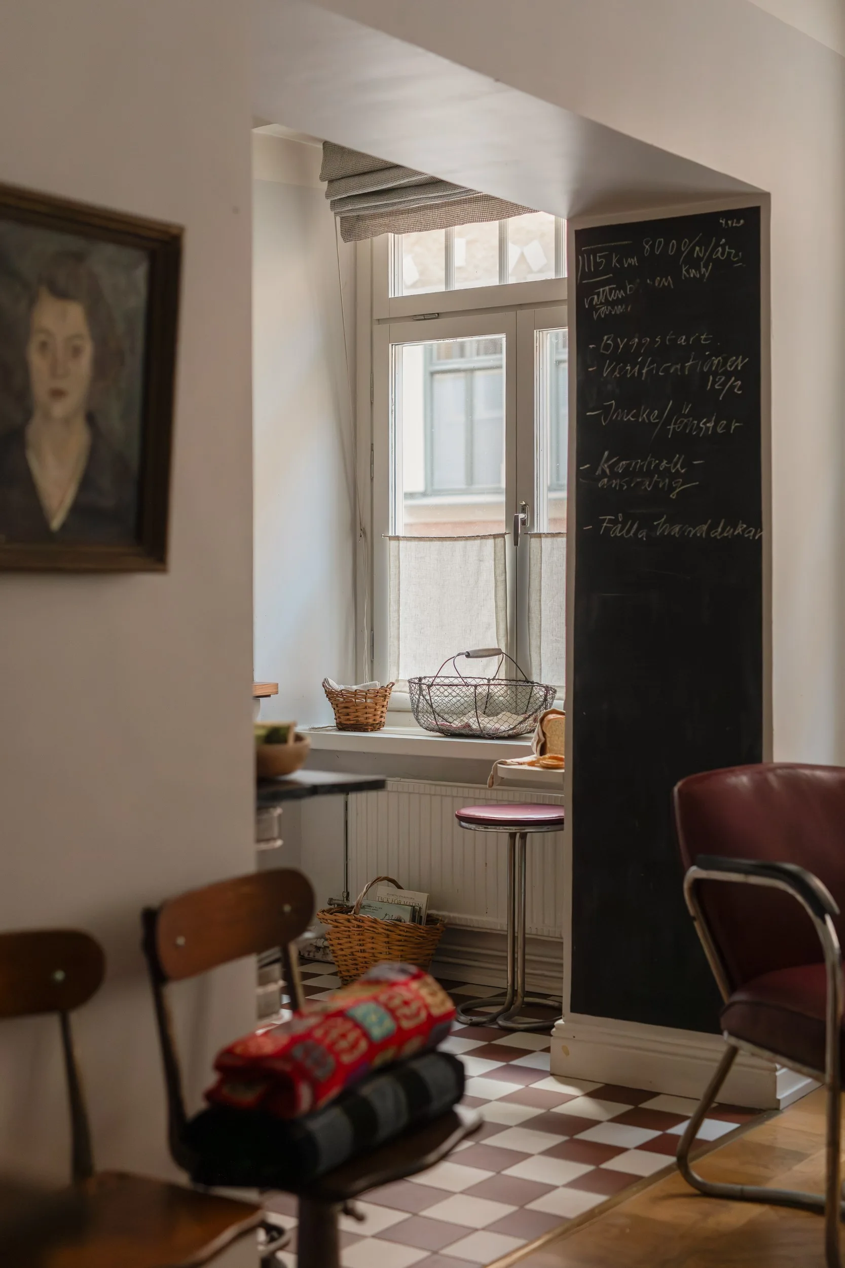 kitchen with checkered red and white floor gray paneled walls vintage decor 55sqm apartment Sweden