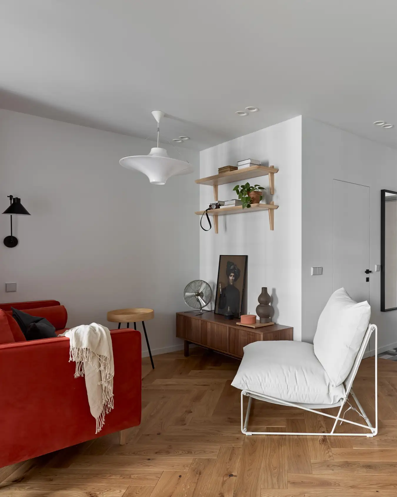 living room with red sofa and walnut TV bench small modern apartment with IKEA furniture