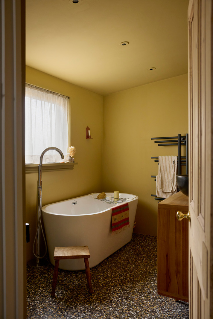 yellow bathroom with terrazzo floor