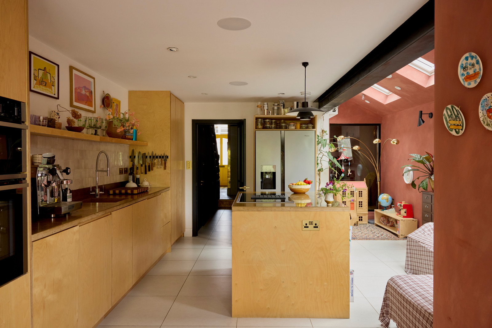kitchen family room with red brick colour walls in a contemporary extension Victorian house Greater London