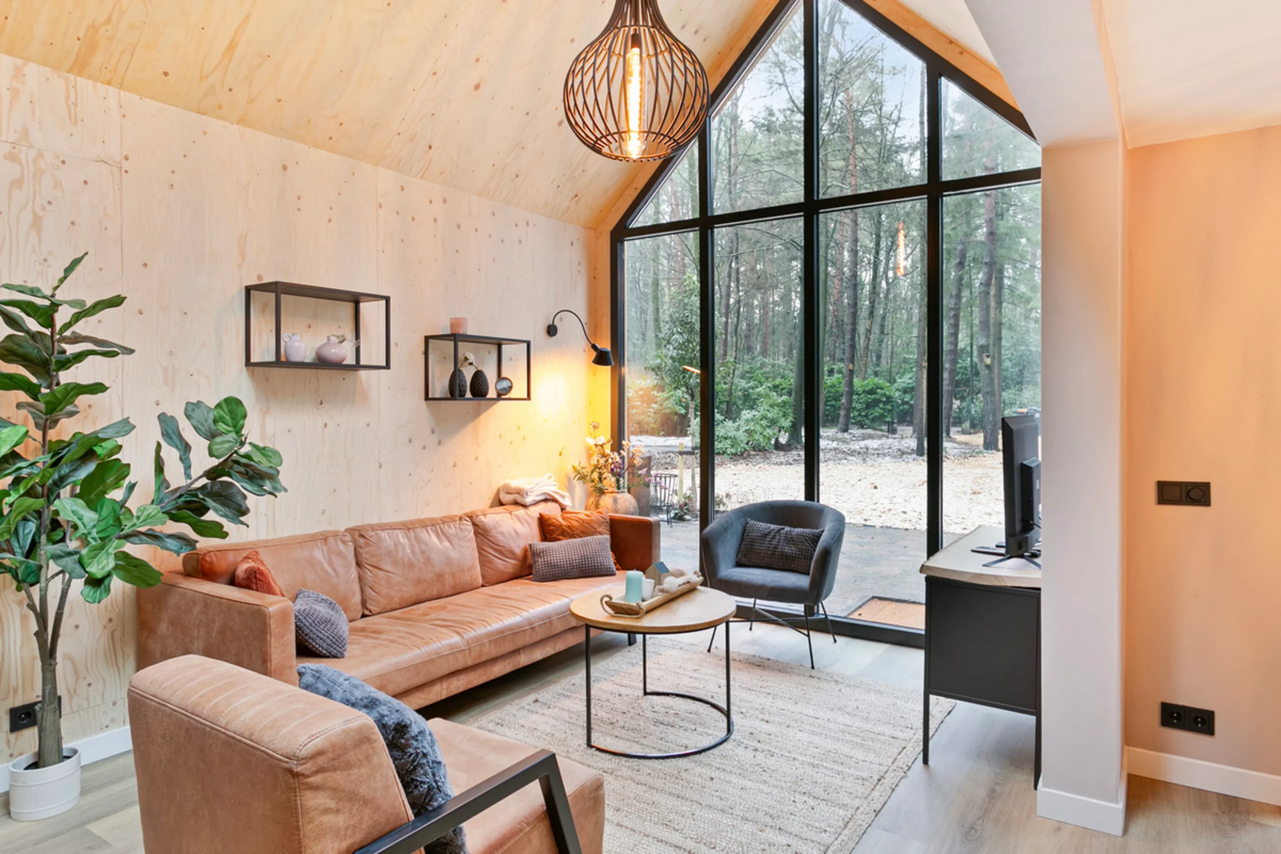 living room with double-height glass gable modern wooden house with lush garden Netherlands living room with double-height glass gable modern wooden house with lush garden Netherlands