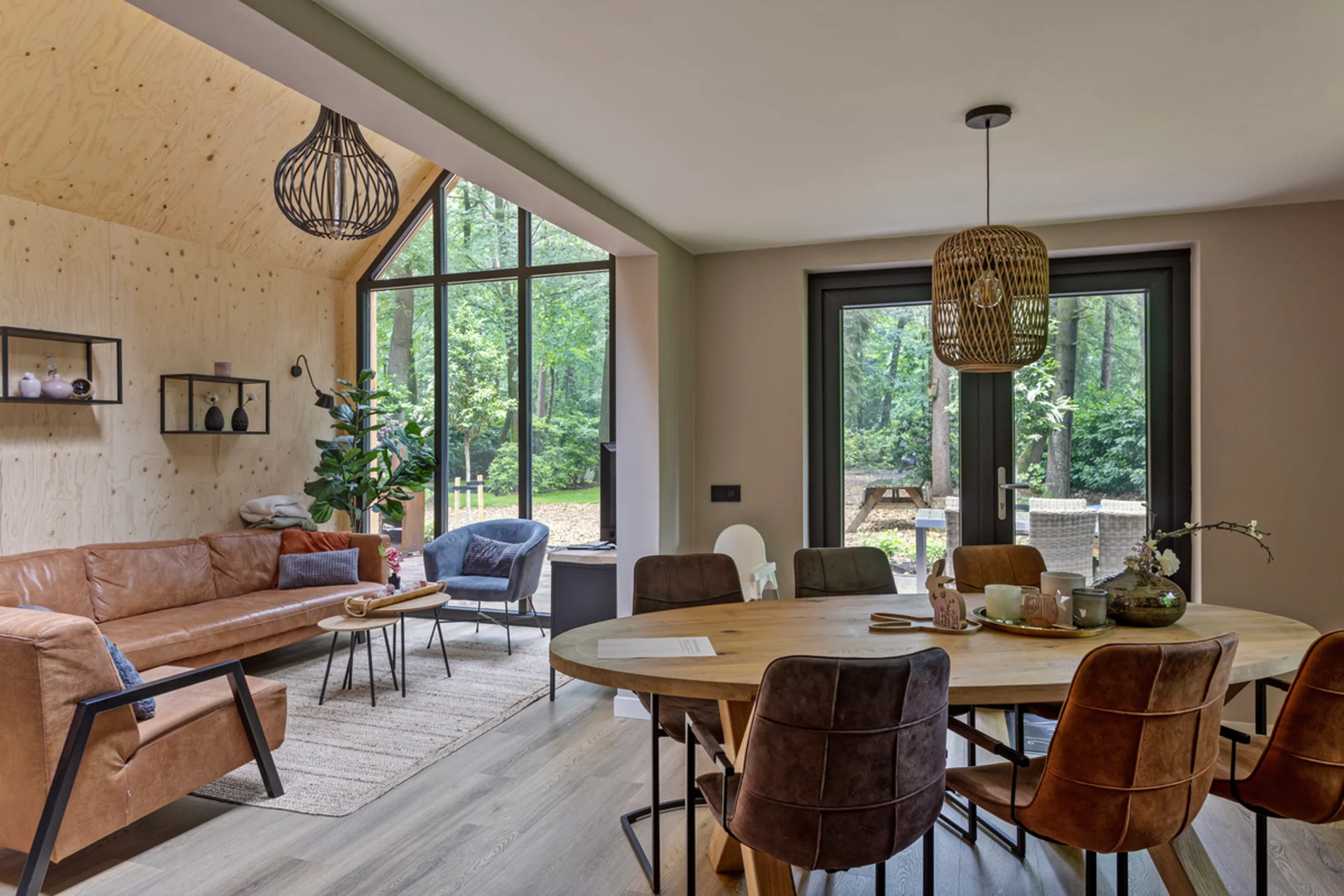 living room with double-height glass gable modern wooden house with lush garden Netherlands living room with double-height glass gable modern wooden house with lush garden Netherlands