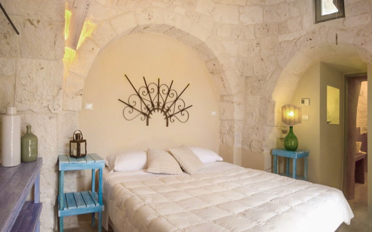 bedroom with archs and stone walls Villa Coki Italy