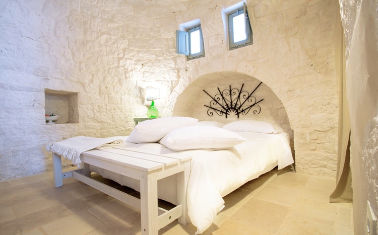 bedroom with archs and stone walls Villa Coki Italy