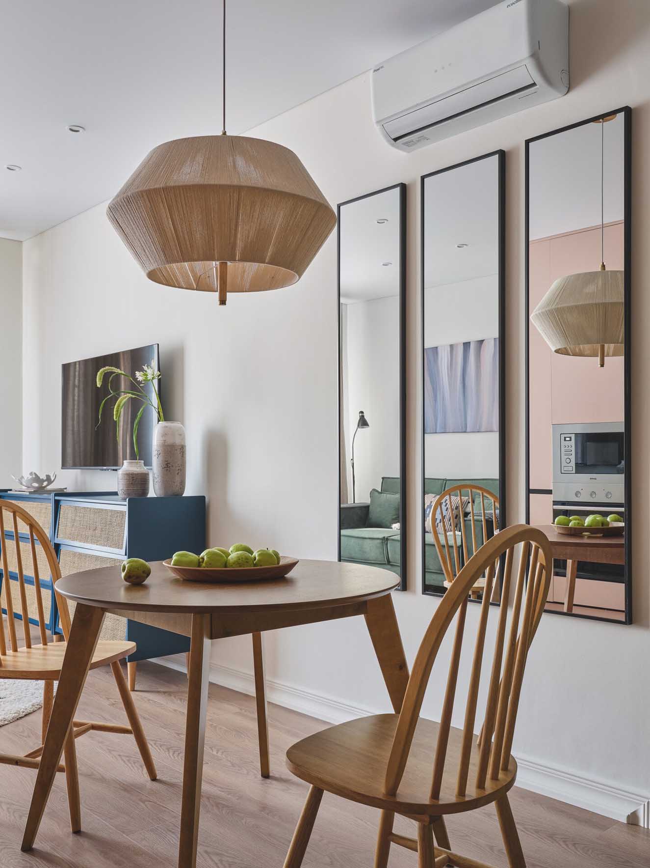 pink kitchen dining room and living room with green sofa in a two-room 42sqm apartment