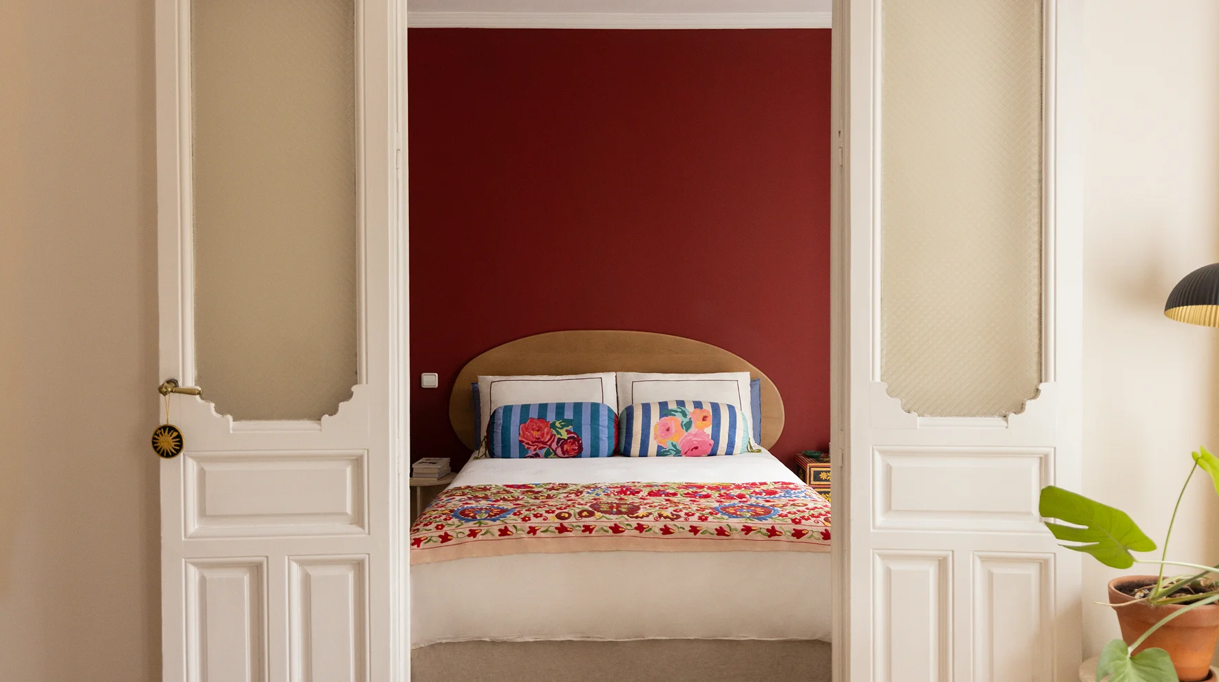 bedroom with red accent wall furnished by Sklum at Elena Cuesta's