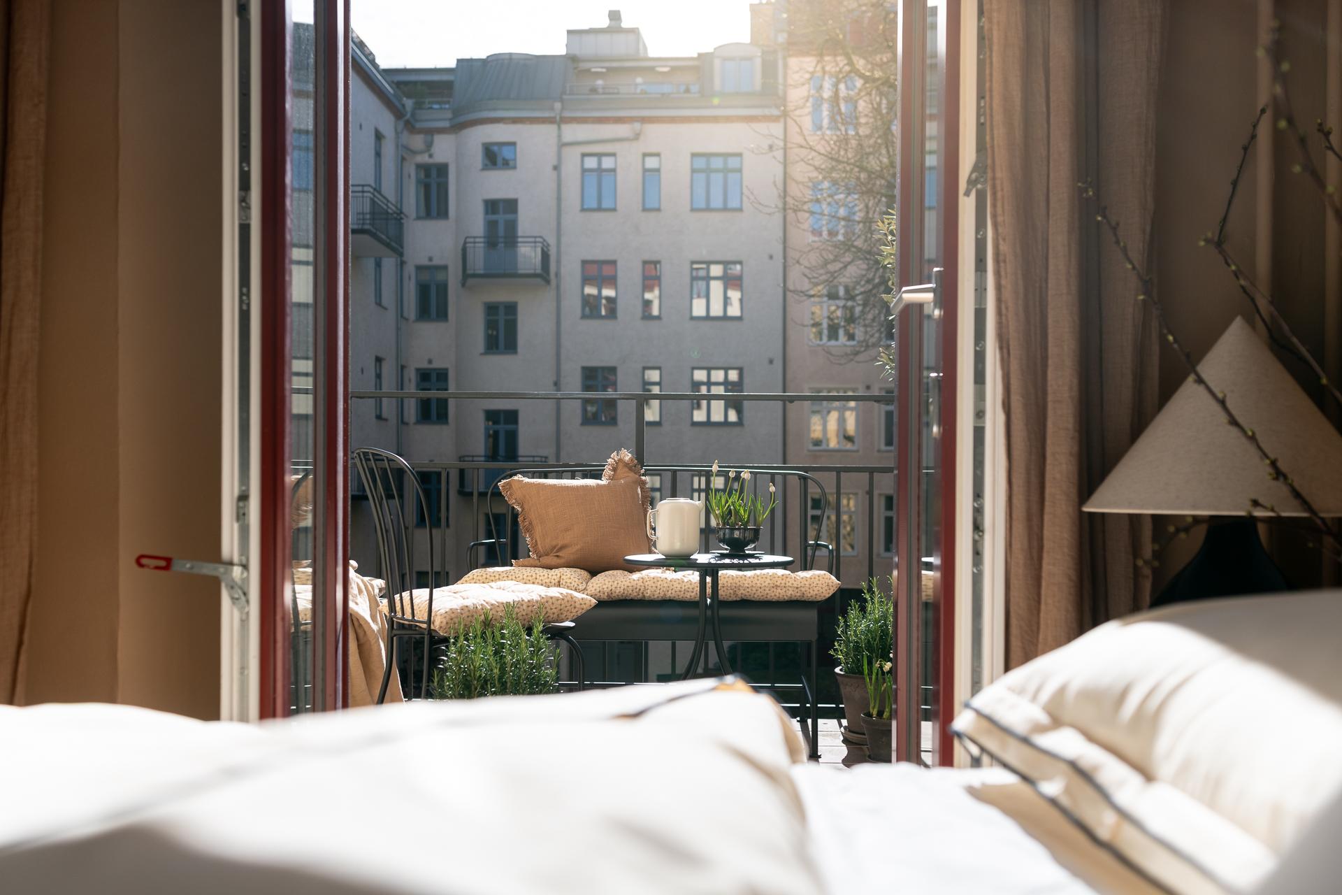 bedroom with walls in light brown shade and balcony