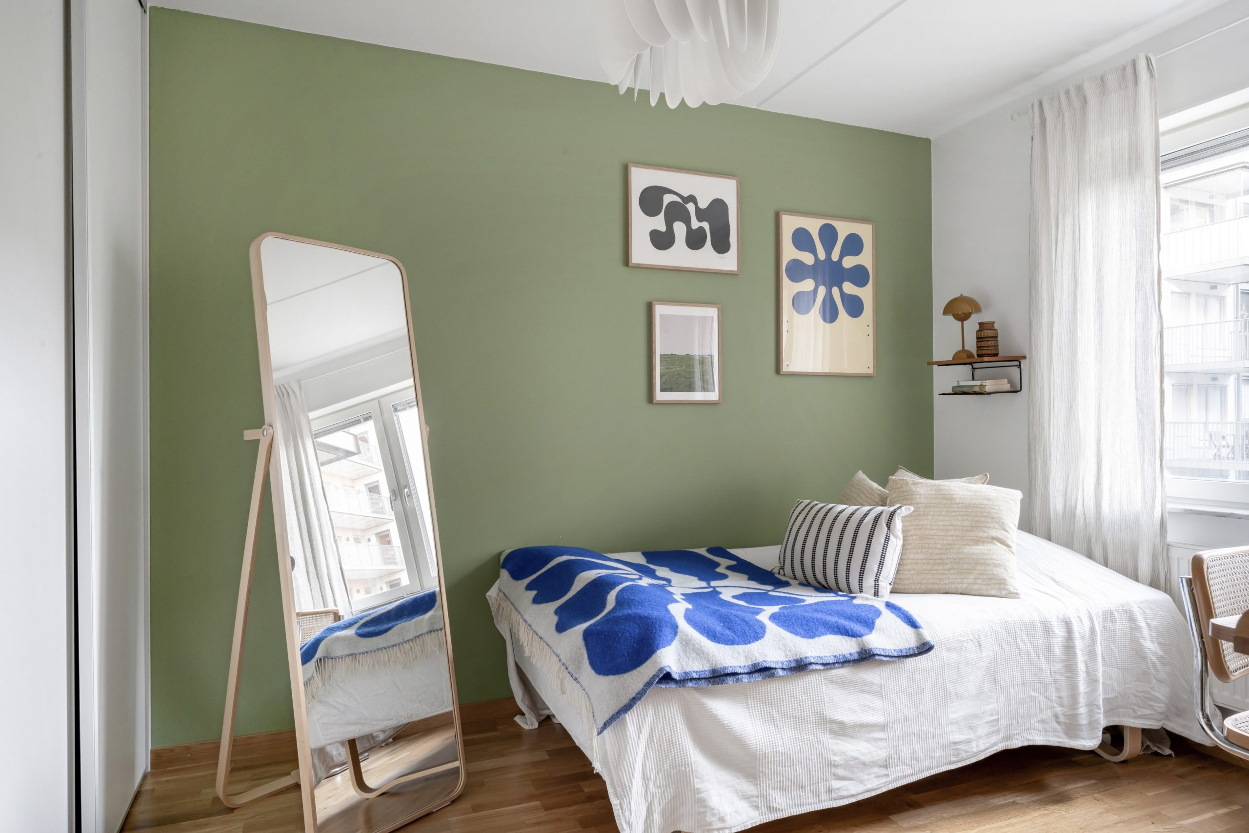 bedroom with an accent green wall and Arket blanket bedroom with an accent green wall and Arket blanket