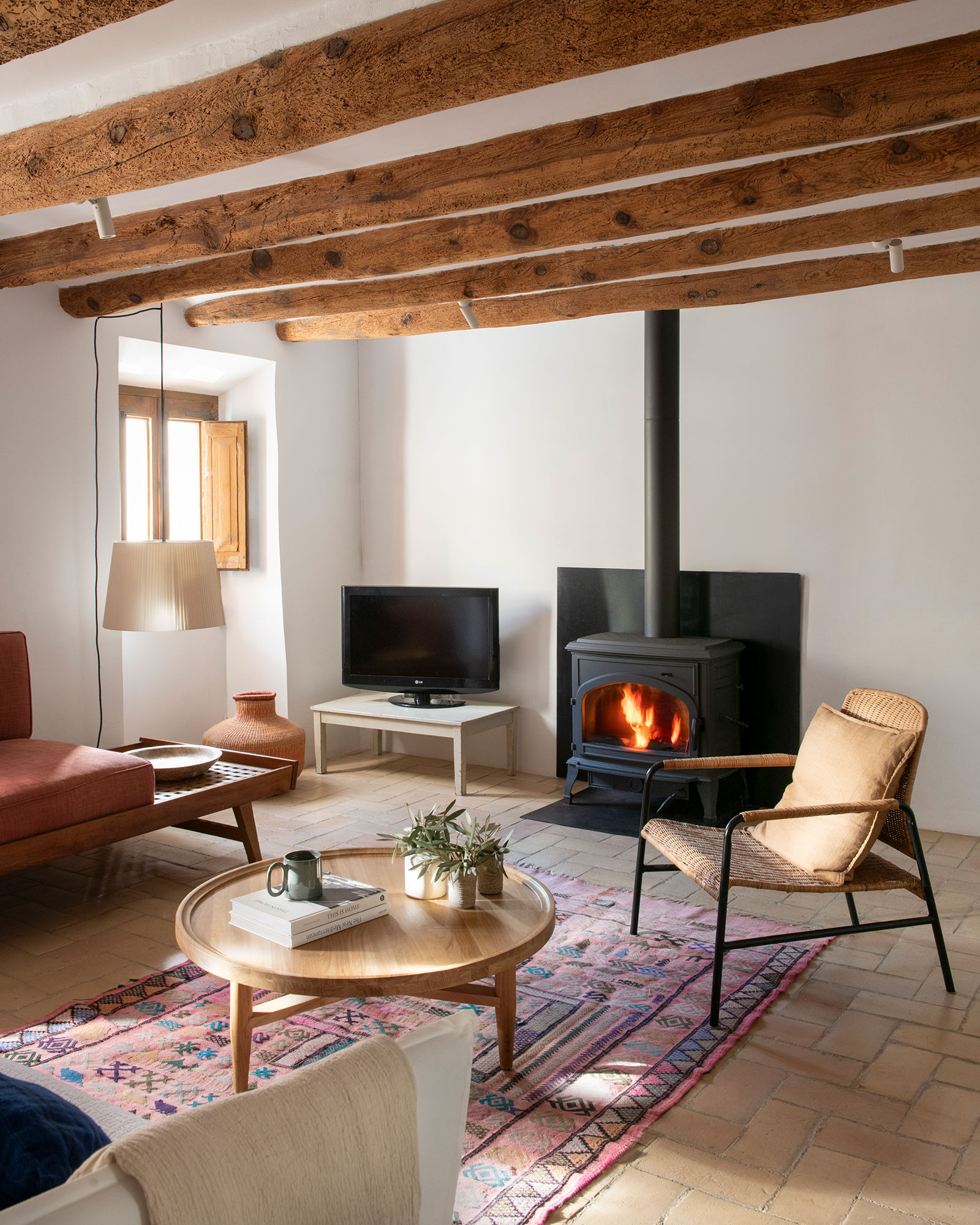 salon avec poêle et avec poutres décoration rustique chic maison de village catalane Casa Maltesa