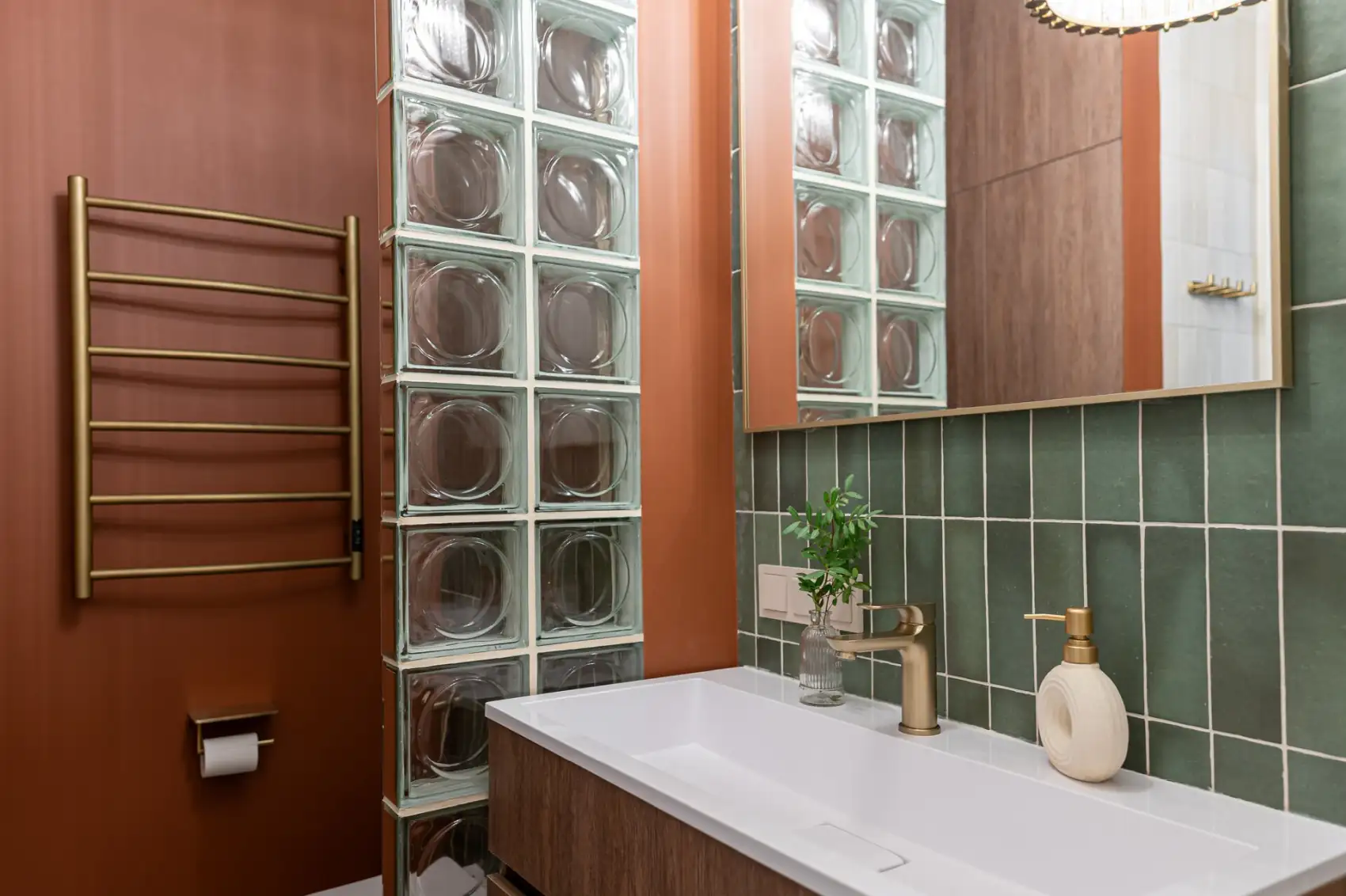 orange and green bathroom with glass blocks