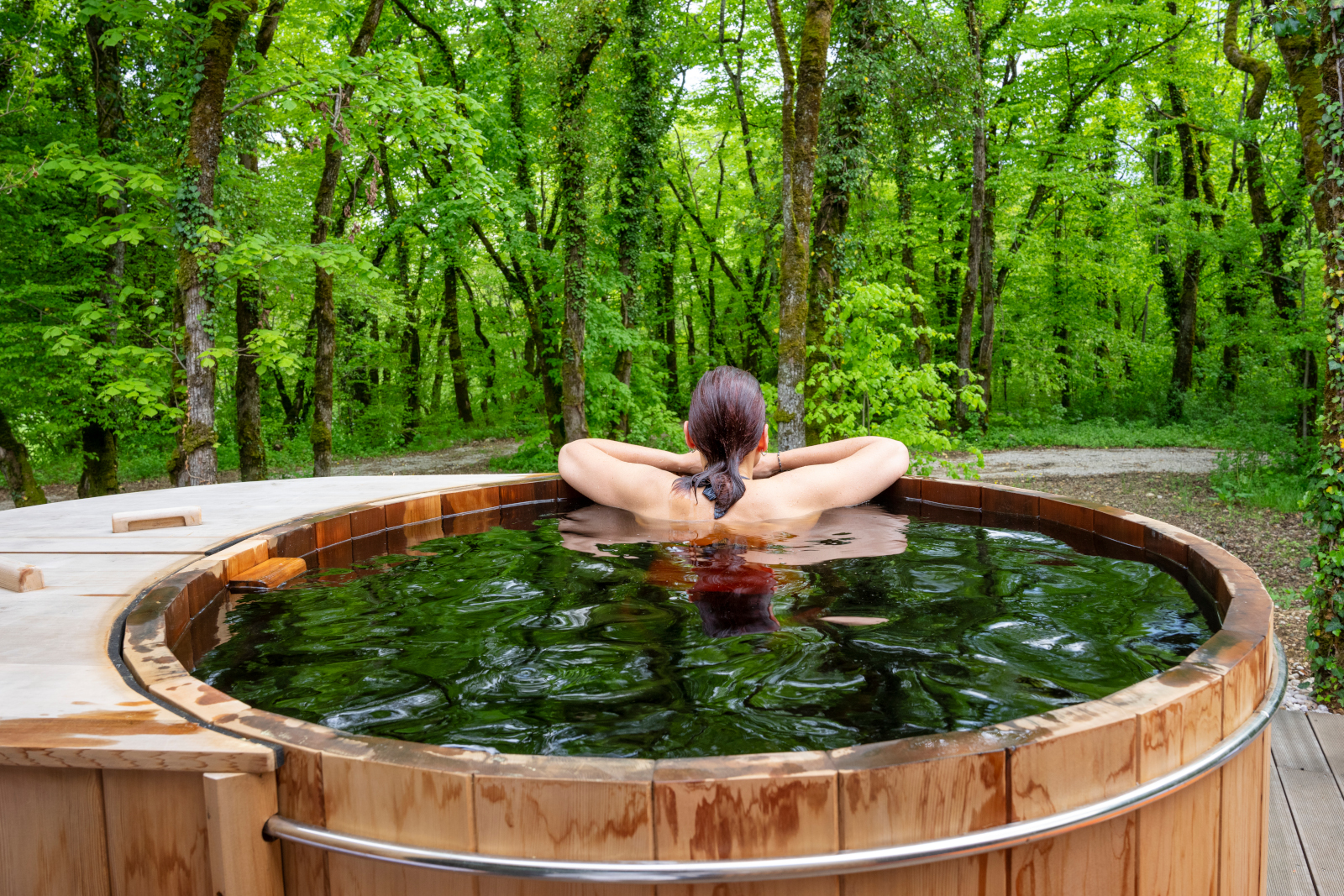 Beautiful woman in nordic bath in front of a forest.