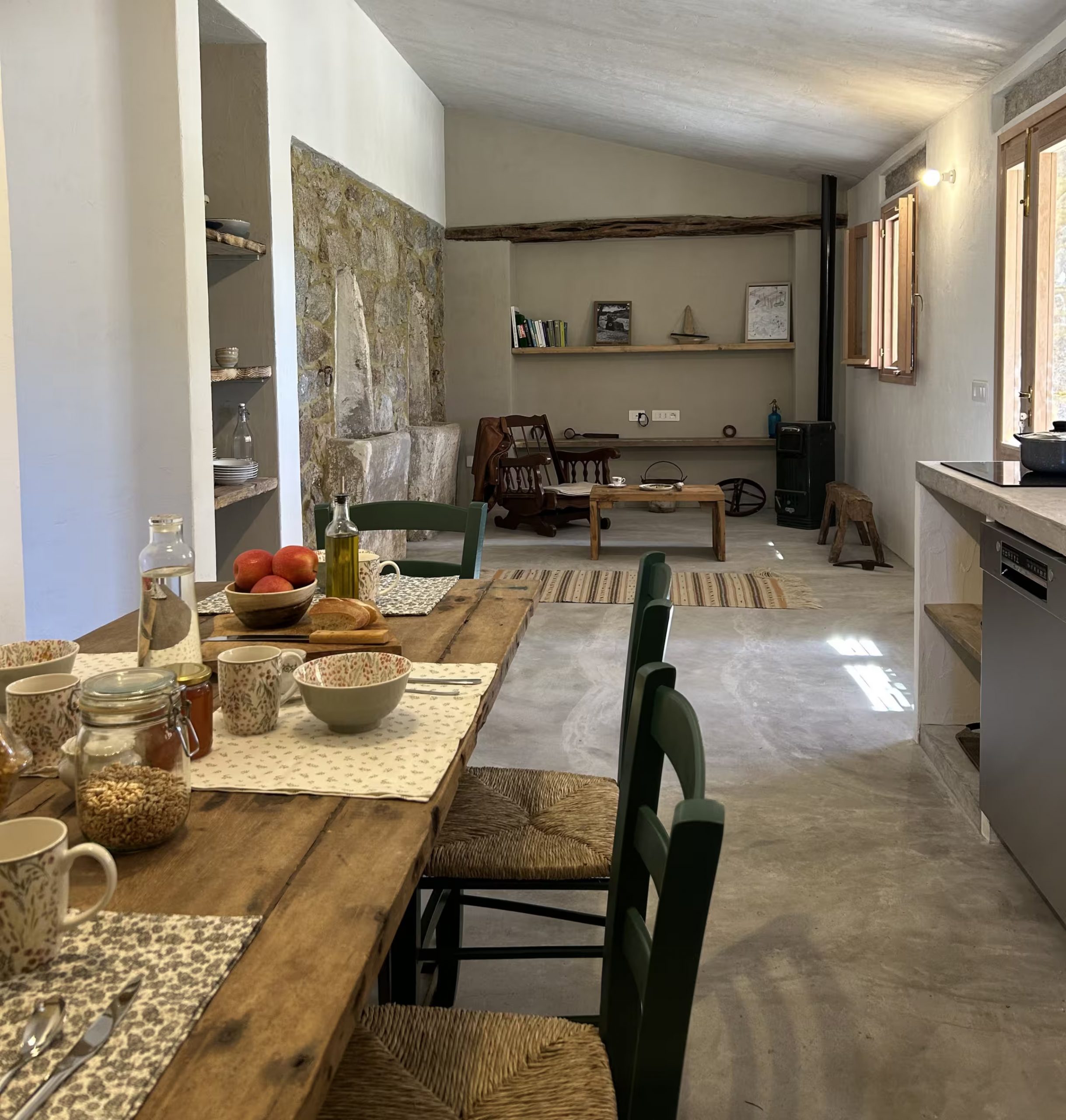 salon avec poêle cuisine ouverte et salle à manger décoration authentique et rustique maison ancienne en Sardaigne