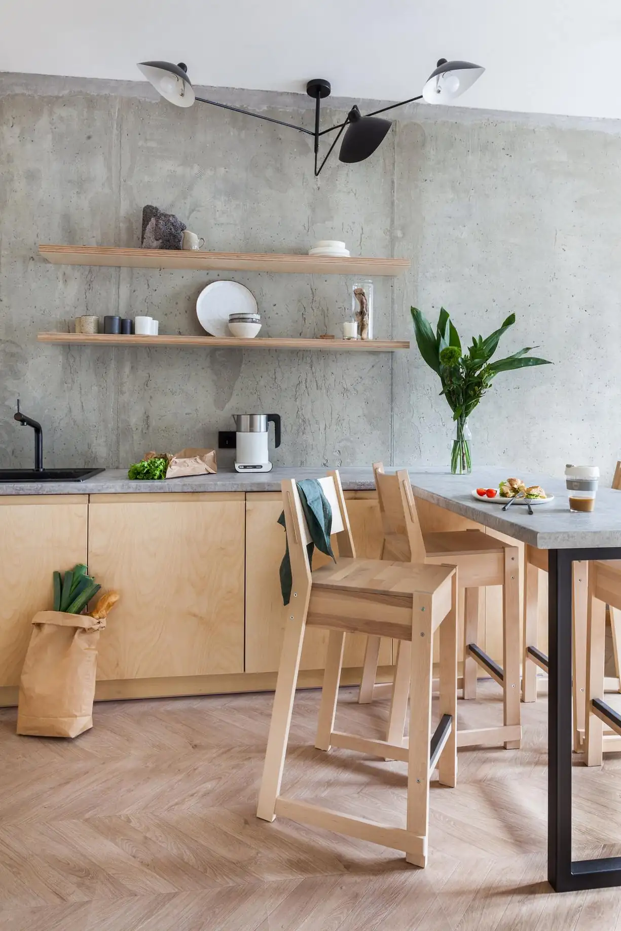 concrete and Plywood modern kitchen in 45sqm apartment with a glass brick partition concrete and Plywood modern kitchen in 45sqm apartment with a glass brick partition